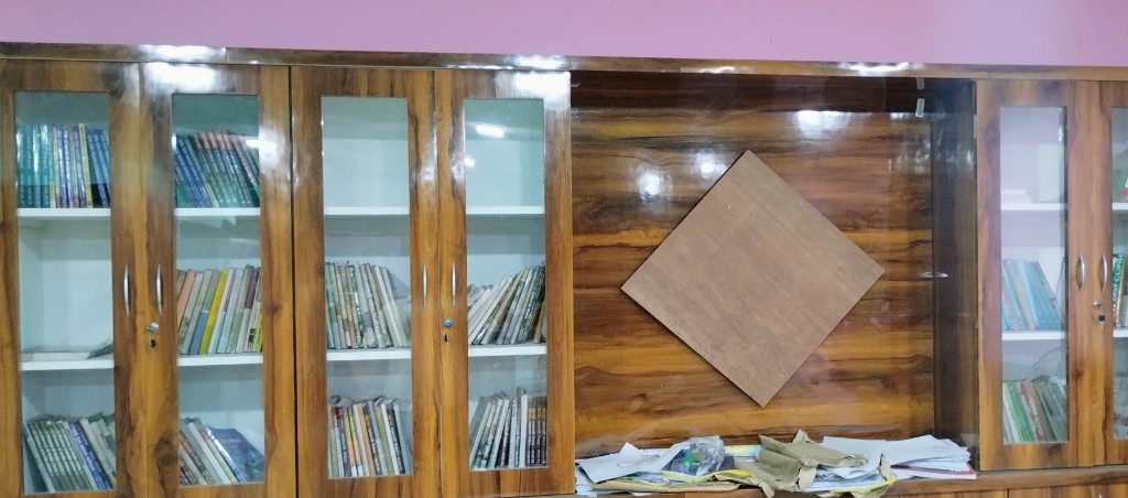 Library reading room with polished wooden table and book cabinets